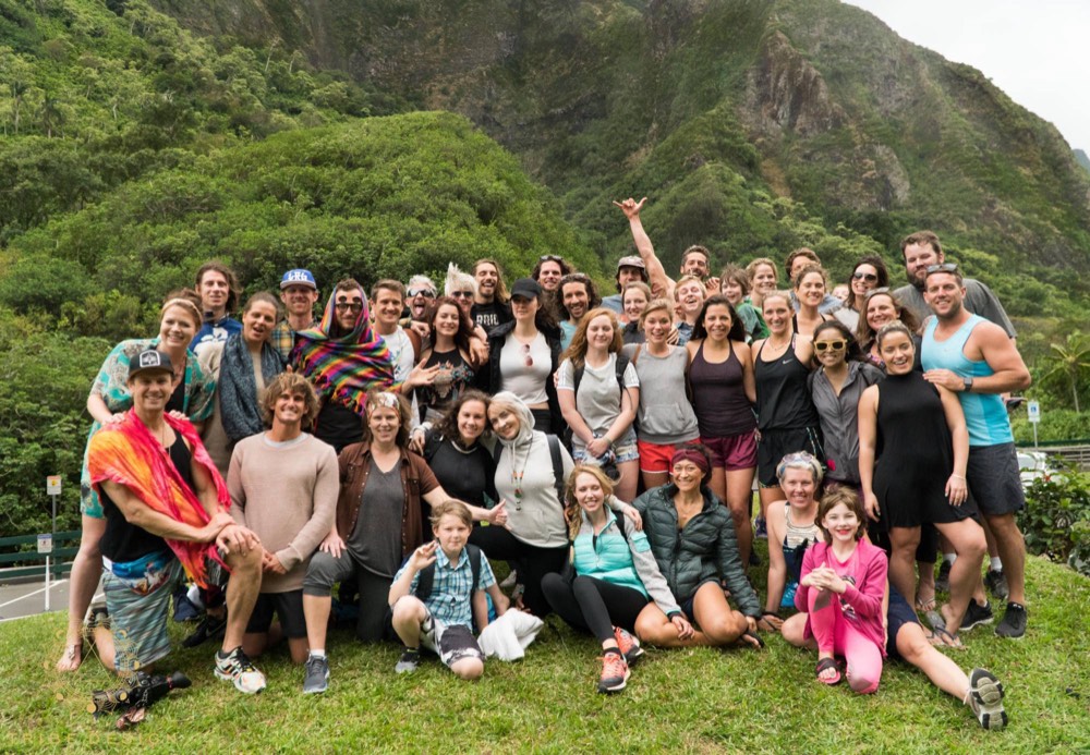 Full retreat group photo in front of a green mountain valley