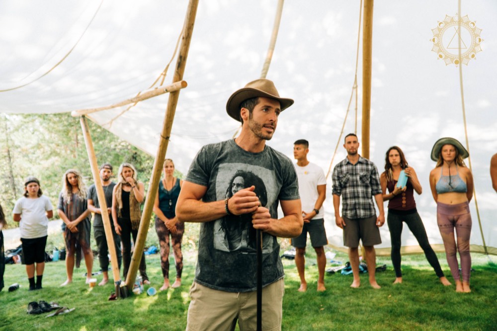 Retreat leader speaking to the group in front of a teepee