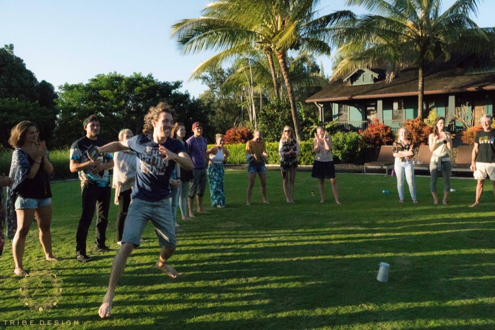 Guest leaping for joy on the lawn as the group cheers